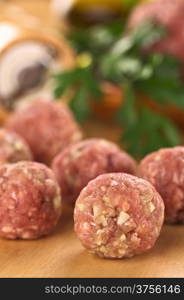 Raw meatballs with garlic (Selective Focus, Focus on the meatball in the front). Raw Meatballs
