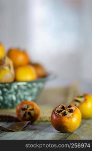 Raw medlars on a rustic wooden table top view