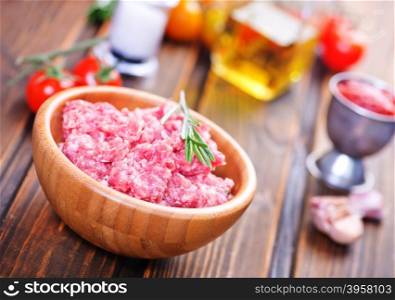 raw minced meat in bowl and on a table
