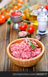 raw minced meat in bowl and on a table