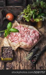 raw minced meat on vintage wooden background. fresh minced meat