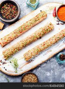 Raw minced meat skewers kebabs. Caucasian popular dish, kebab from young lamb meat and spices