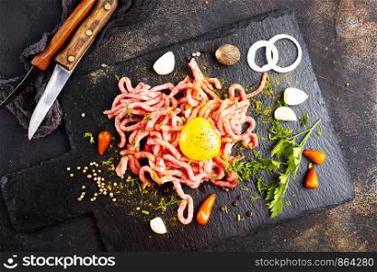 Raw minced meat with egg, herbs and spices