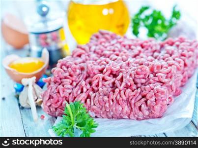 raw minced meat with spice and salt on a table