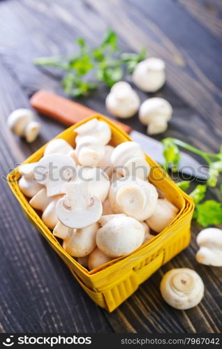 raw mushroom in basket and on a table