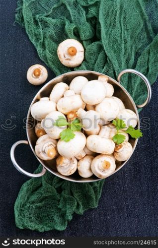 raw mushrooms in bowl and on a table