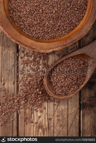 Raw natural organic linseed flax-seed in wooden spoon on wood background. Healthy omega 3 product.