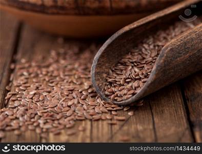 Raw natural organic linseed flax-seed in wooden spoon on wood background. Healthy omega 3 product.