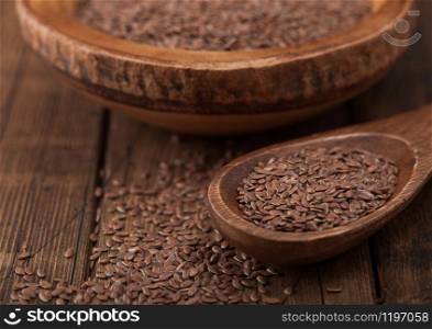 Raw natural organic linseed flax-seed in wooden spoon on wood background.Macro