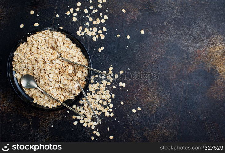 raw oat flakes in bowl on a table