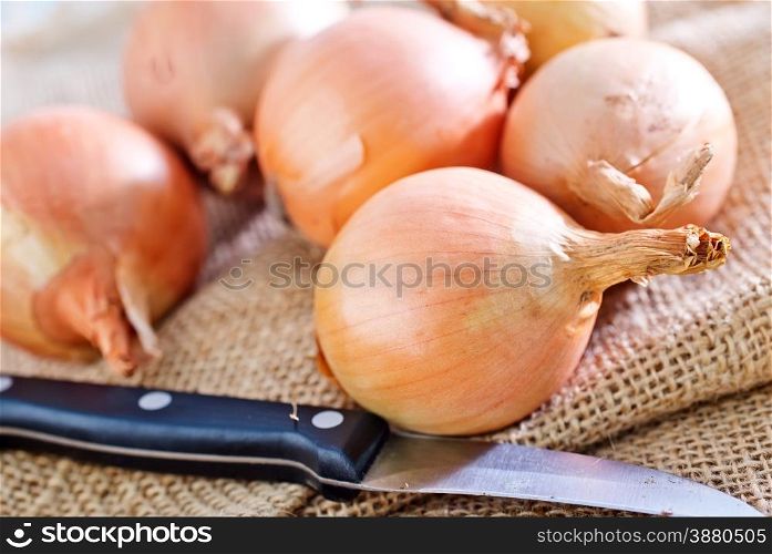 raw onion on sack and on a table