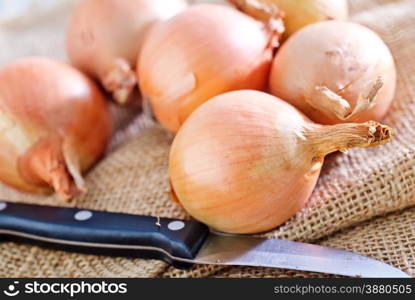 raw onion on sack and on a table