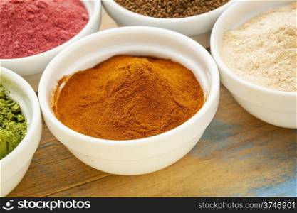 raw organic dried mangosteen fruit powder in a small ceramic bowl