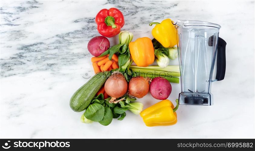 Raw organic vegetables and blender on marble stone background for healthy diet drink concept