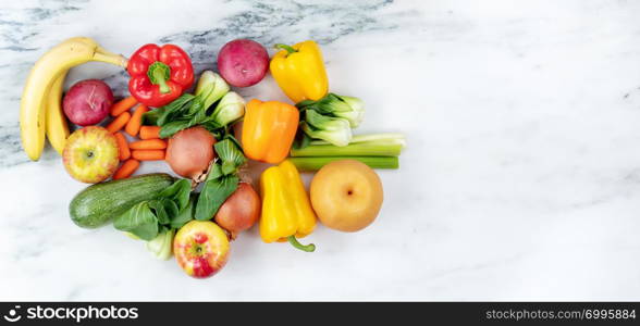 Raw organic vegetables and fruits on marble stone background for healthy diet concept