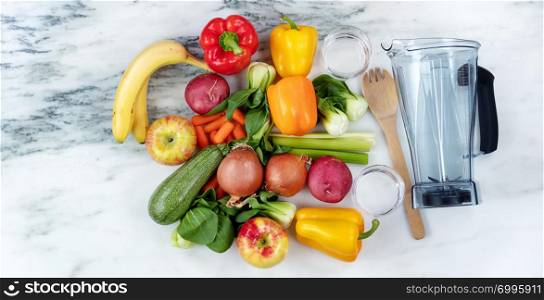 Raw organic vegetables and fruits with blender on marble stone background for healthy diet drink concept
