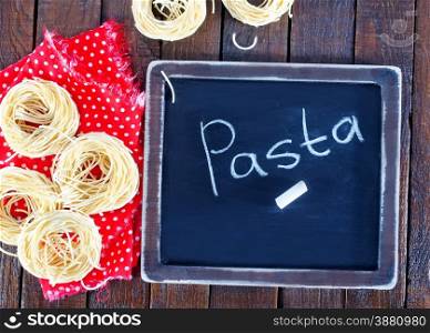 raw pasta and black board for menu and recipe