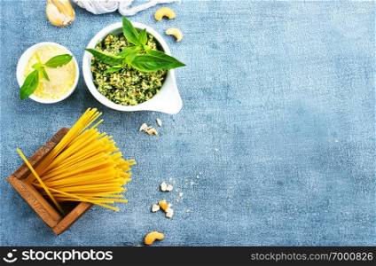raw pasta cheese and pesto sauce in bowl