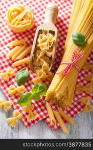 raw pasta farfalle spaghetti penne tagliatelle. italian cuisine