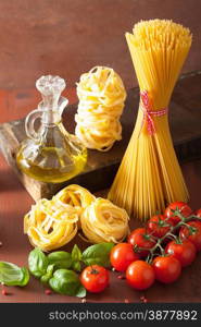 raw pasta olive oil tomatoes. italian cooking in rustic kitchen