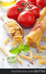 raw pasta olive oil tomatoes. italian cuisine