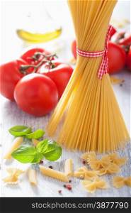 raw pasta olive oil tomatoes. italian cuisine