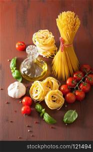 raw pasta olive oil tomatoes. italian cuisine in rustic kitchen