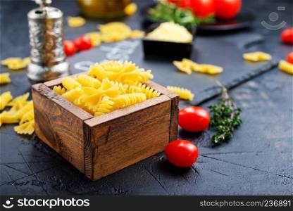 raw pasta on a table, raw pasta and fresh tomato
