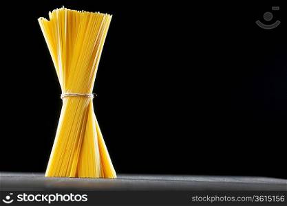 Raw pasta on black table