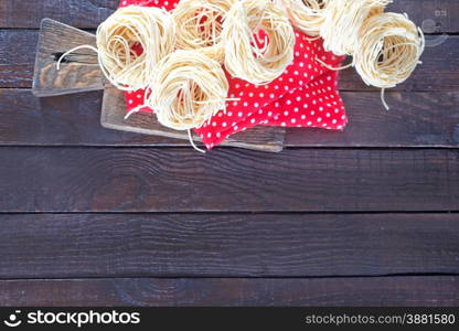 raw pasta on napkin and on the wooden table