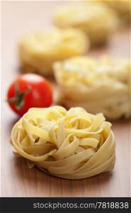raw pasta tagliatelle and tomatoes