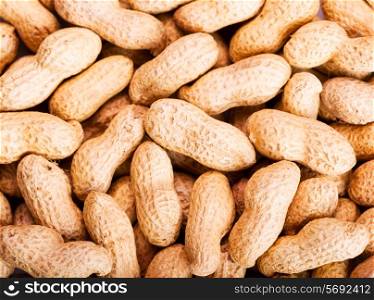 raw peanuts in shells as background