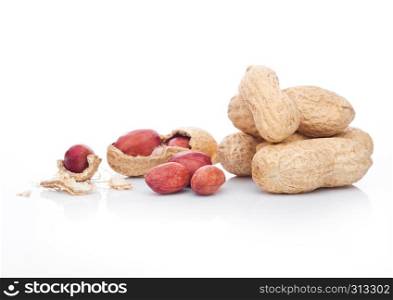 Raw peanuts with shell on white background with reflection