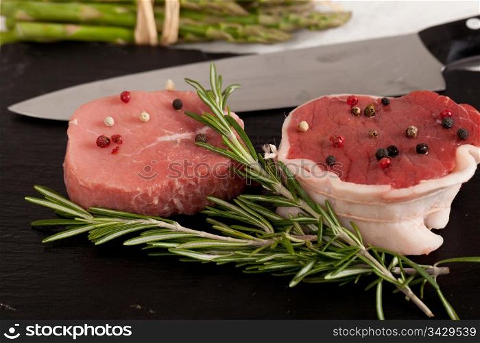 Raw piece of beef with rosemary