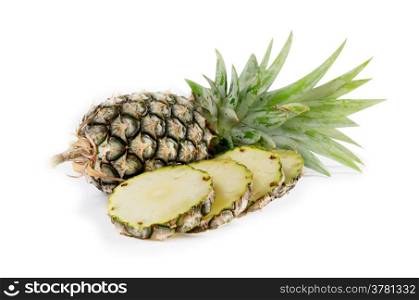 raw pineapple and sliced pineapple on white