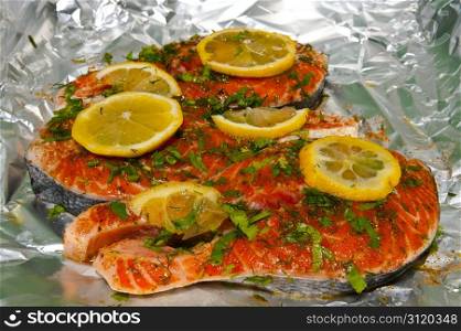 Raw Pink Salmon with Herbs and Lemon on the Aluminum Foil