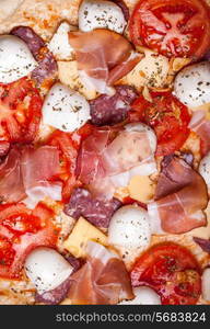 Raw pizza dough with mozzarella and proscuitto on top