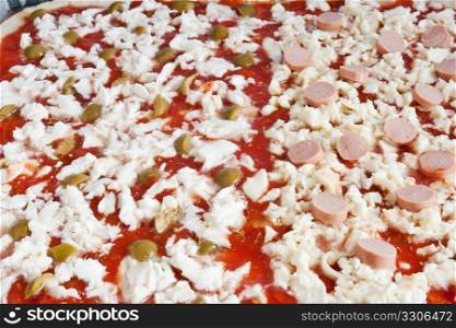 raw pizza with tomato mozzarella olives and wurstel