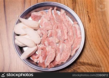Raw pork on plate, Korean traditional style fresh pork beef belly BBQ, Japanese meat hot pot or Shabu in the restaurant, barbecue food