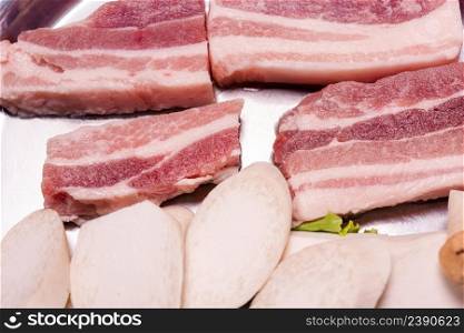 Raw pork on plate, Korean traditional style fresh pork beef belly BBQ, Japanese meat hot pot or Shabu in the restaurant, barbecue food