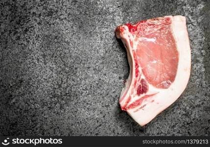 Raw pork steak. On rustic background. Raw pork steak.