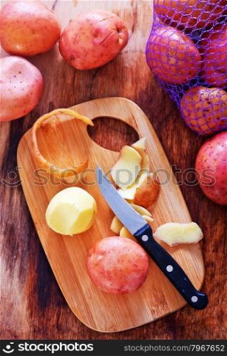 raw potato and knife on a table