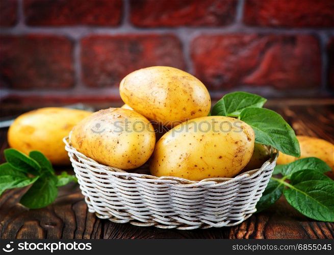raw potato in basket and on a table