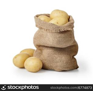 Raw potatoes in burlap bag isolated on white background with clipping path
