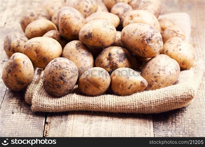 raw potatoes on a wooden table