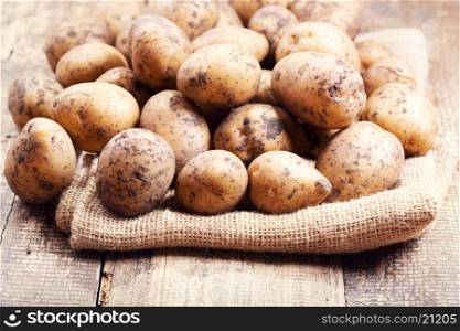 raw potatoes on a wooden table