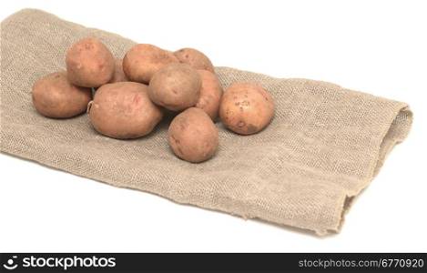 raw potatoes on burlap sack isolated on white