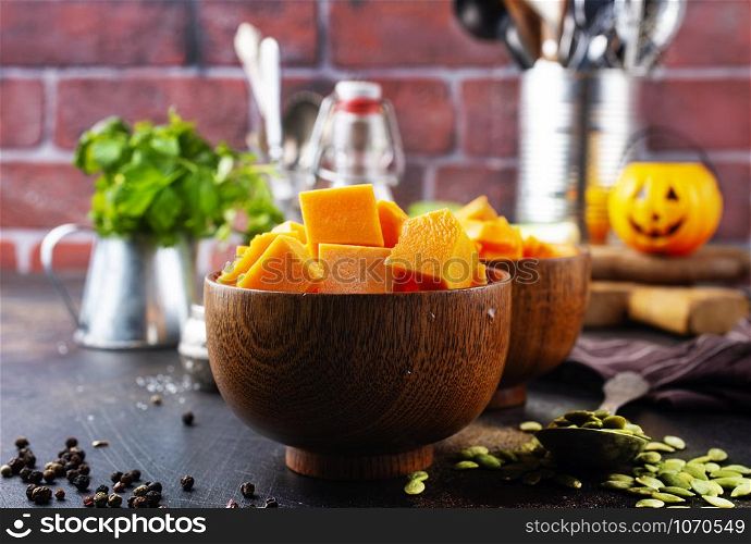 raw pumpkin and herbs spice on a table
