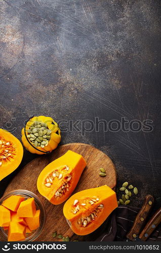 raw pumpkin and pumpkin seed on board