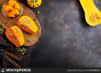 raw pumpkin and pumpkin seed on board